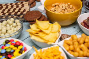 Table of salty and sweet snacks. Large group of unhealthy food