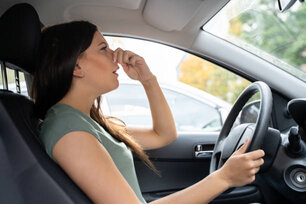 Woman Covering Her Nose From Bad Smell Inside The Car