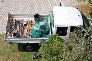 pickup of a gardening team with tools on loading area