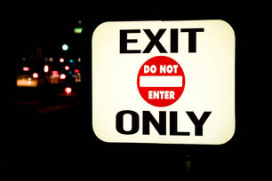 Illuminated sign outside an exit of the car park with a Do Not Enter symbol