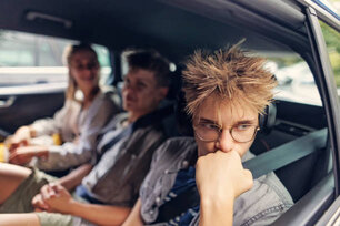 Three tired teenager kids travelling by car in Cotswold, United Kingdom. Shot with Canon R5