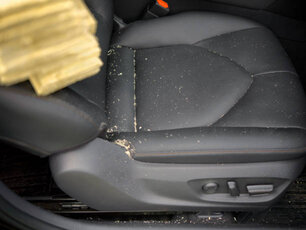 Sawdust on a leather car seat, modern car interior close-up